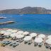 Orsmaris Boutique Hotel in Marmaris with beach loungers, white umbrellas, and sea and mountain views