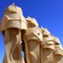 Cuatro Naciones in Barcelona, sculptural rooftop chimneys against a clear blue sky