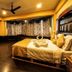Welcome Hotel at Srinagar bedroom with king bed, dark wood floor, seating area and patterned curtains