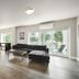Solo Suites in Victoria living area with sectional sofa, coffee table, and floor-to-ceiling windows