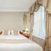 44 Curzon Street by Mansley in London bedroom with king bed, bedside lamps, and tall curtained window