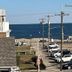 Quaker Inn in Ocean Grove with oceanfront view, parked cars, and nearby beach seen beyond rooftops