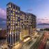 Grand Josun Busan hotel tower at dusk with ocean and city street views in Busan