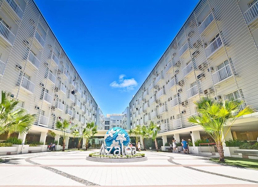 Azalea Hotels & Residences Boracay courtyard with twin hotel wings, palm trees and blue sky