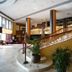 Benakutai Hotel and Apartemen Balikpapan lobby with sweeping curved staircase