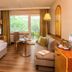 Akzent Hotel Berlin in Bad Bevensen guest room with balcony doors, sofa, chair and desk
