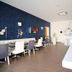 Hotel Noto Marina Vista Mare in Noto breakfast room with tables, chairs, wall TV and bar counter