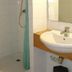 Chalet Hotel Aiguille Blanche Logis in Les Gets bathroom with shower, sink, and toilet