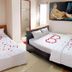 Ban Mai Hotel 66 in Phan Thiet room with two beds decorated with heart-shaped flower petals