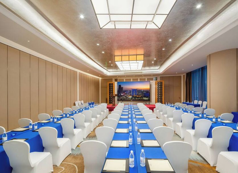 Dongguan Kande International Hotel banquet hall with rows of white chairs and blue table settings in Dongguan
