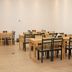 Yiwu Mango Hotel in Jinhua dining area with wooden tables and black chairs