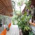 Hotel Coco Beach in Manuel Antonio: tropical garden walkway beside glass-walled dining area