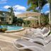 Montpellier Boutique Resort in Noosaville with resort pool, palm trees, and sun loungers