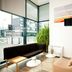 Séjours & Affaires Paris-Vitry lobby with sofa, tables, plant, wall art and street views in Vitry-sur-Seine