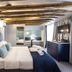 The Lift Boutique Hotel by Ridan Hotels in Lisbon: stylish bedroom with exposed beams and wall mural