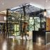 Eurostars Palace Córdoba lobby with illuminated tree mural, wood floors and reception desk