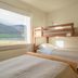 Seydisfjördur Guesthouse in Seydisfjordur room with bunk bed, twin bed and mountain-view window