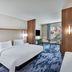 Fairfield by Marriott Inn & Suites Aberdeen, SD guest room with king bed, desk, TV, and window seating