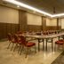 Extenso Hotel in Izmir conference room with long boardroom table and red chairs