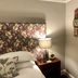 Westwood House, Dorchester guest room with floral headboard, bedside lamp and patterned wall art
