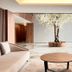 Acta The Avenue Porto lobby with a central flowering tree, round coffee table and curved sofa