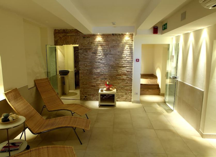 Riviera Mare Beach Life Hotel in Rimini spa lounge with wooden sunbeds and a brick wall