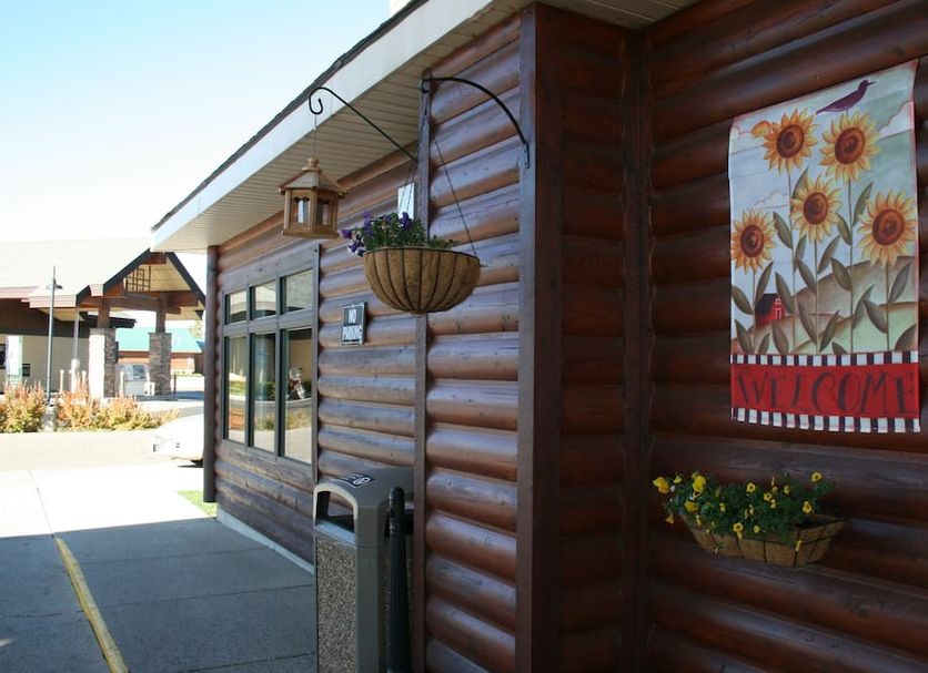 Yellowstone Lodge in West Yellowstone exterior with rustic log siding and sunflower wall art