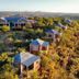 River Crossing Lodge in Windhoek with hillside chalets and a lodge overlooking the valley