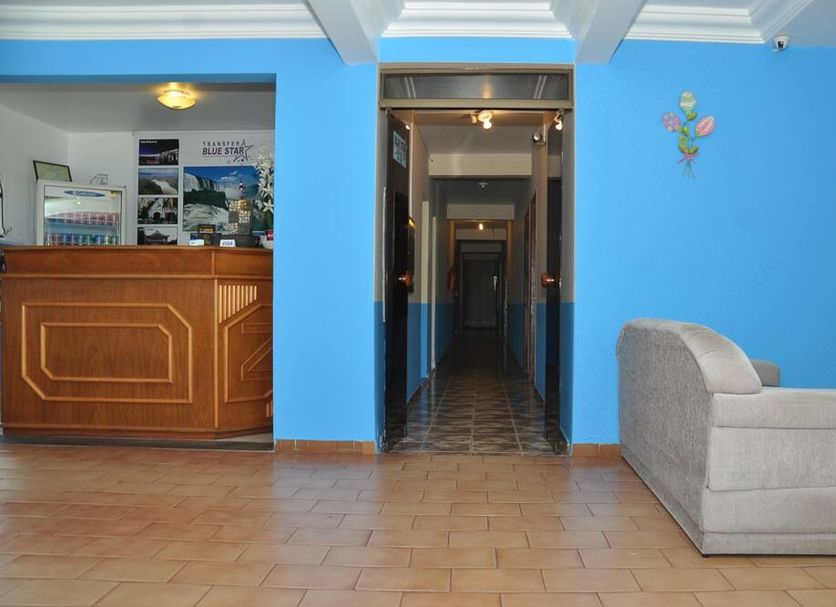 Hotel Blue Star II in Foz do Iguaçu lobby with reception desk, blue walls and tiled hallway