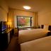Towada Prince Hotel in Kosaka guest room with two beds and a window view of autumn trees