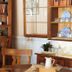 Julian Gold Rush Hotel in Julian, cozy guest room with wooden shelves, table, and sunlit window