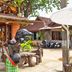 Lanta White Rock in Ko Lanta with outdoor seating, tropical greenery and a carved wooden bear statue