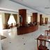 Mawlamyine Strand Hotel restaurant in Mawlamyine with tables, chairs, and a central wooden counter