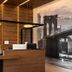 Hotel Mirage Brooklyn reception desk with wood-paneled interior and Brooklyn Bridge wall art