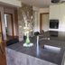 7th Mill apartments, Kranj: modern apartment kitchen with island, sink, built-in oven and dining area