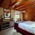 Whiteface Farm Adirondack Bed and Breakfast room in Wilmington with wood-paneled sloped ceiling and queen bed