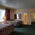 Ocean Beach Hotel Miami Beach room with two beds, TV, dresser, and mirrored closet