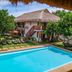 Scent of Green Papaya in Panglao with outdoor pool, lounge chairs, and thatched-roof villas