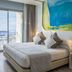 AZ Hotel Vague D'or Algiers room with balcony sea view, double bed and colorful wall art