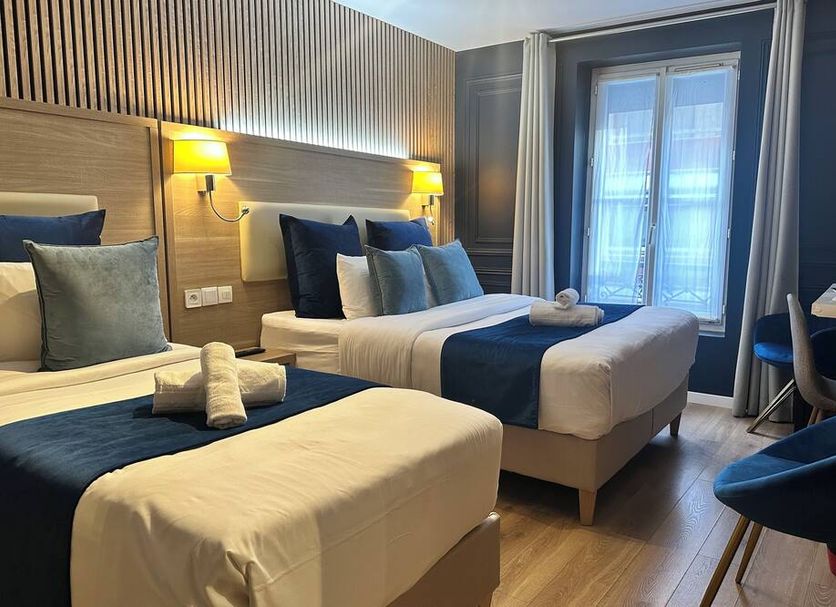 Hôtel Clairefontaine Paris guest room with two twin beds and French doors to a balcony