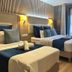 Hôtel Clairefontaine Paris guest room with two twin beds and French doors to a balcony