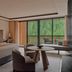 Aman Rosa Alpina guest room in Badia/Abtei with bed, seating area, and forest-view balcony