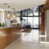 Krista Boutique Hotel Buenos Aires lobby with wood reception desk and hanging pendant lights