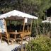 Tigullio Camping & Resort in Sestri Levante, outdoor gazebo seating area with wooden table and benches