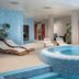 Crowne Plaza Vilnius indoor spa with circular pool, lounge chairs and plants in Vilnius