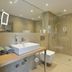 Parkhotel Oberhausen bathroom with walk-in shower, wall-mounted sink, and towel warmer in Oberhausen
