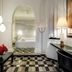Hotel Maya del Mar in Playa del Carmen: stylish suite with arched doorway, checkered floor, and bed alcove