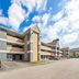 MainStay Suites Knoxville - Cedar Bluff in Farragut, exterior with parking lot and cloudy sky
