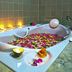 Oriental Siam Resort in Chiang Mai: flower-petaled soaking tub with candles in a spa bathroom