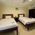Panglao Regents Park Resort room with two single beds, ceiling fan, and air conditioner in Panglao